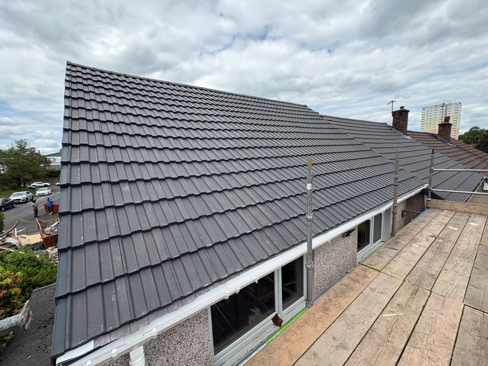 Grey tiled roof above a row of windows
