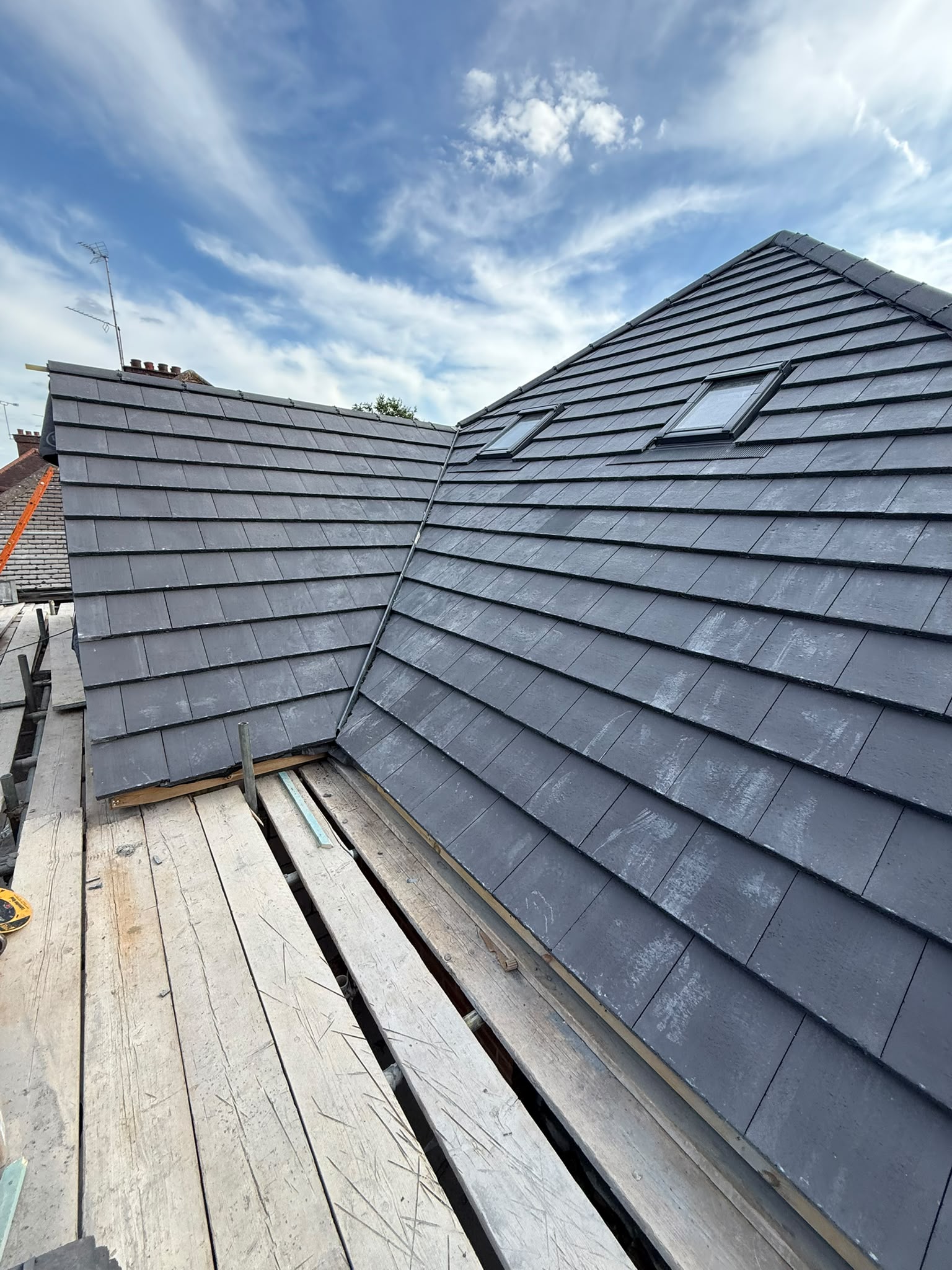 Grey roof tiles adjoining a dormer