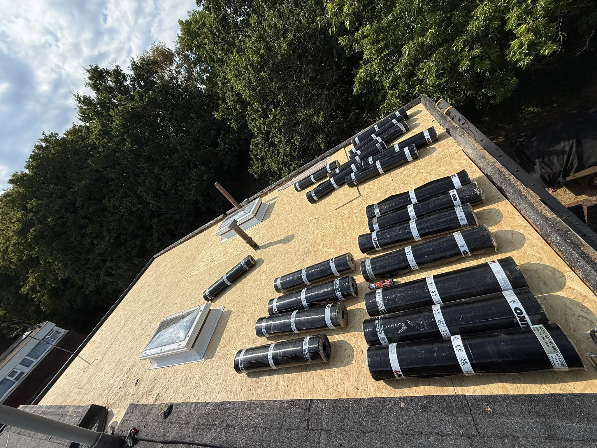 Roof boards and rolls of roofing material before installation